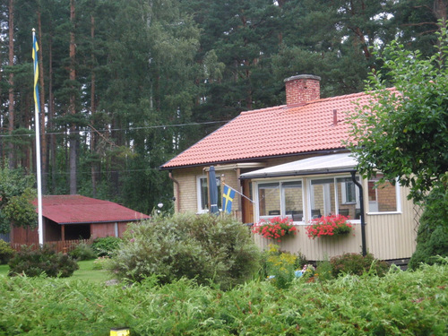 Light Yellow Home with Swedish Flag.